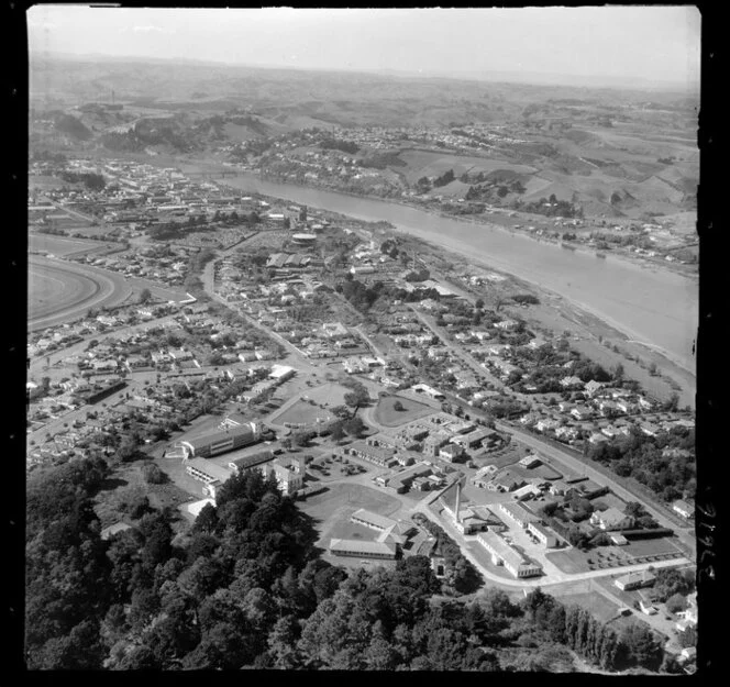 Wanganui, closeup of the Wanganui Public Hospital with Heads Road and residential housing, with the Whanganui River and farmland beyond