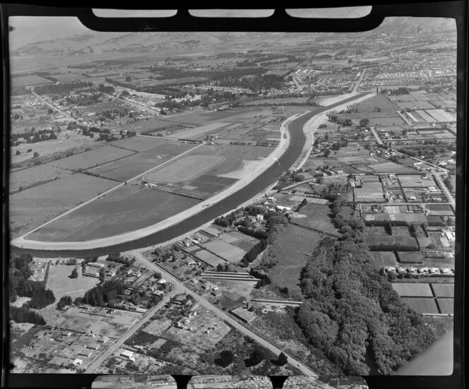 An aerial view of Burwood Primary School, including the construction of New Brighton Road and Avonside Drive, Christchurch