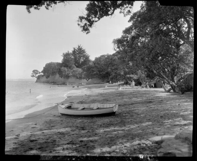 Little Manly, Whangaparaoa Peninsula, showing people and dinghy at the beach