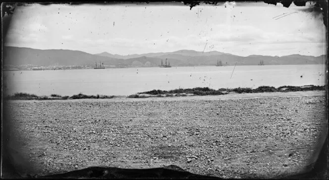 View from Oriental Bay looking towards Thorndon, Wellington, showing four large ships sailing in Lambton Harbour