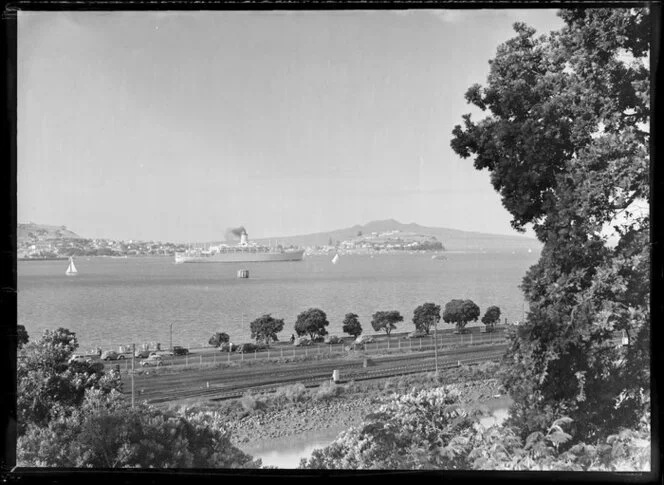 Steamship 'Orsova' in Auckland Harbour, Judges Bay (foreground), Devonport and Rangitoto Island in the distance