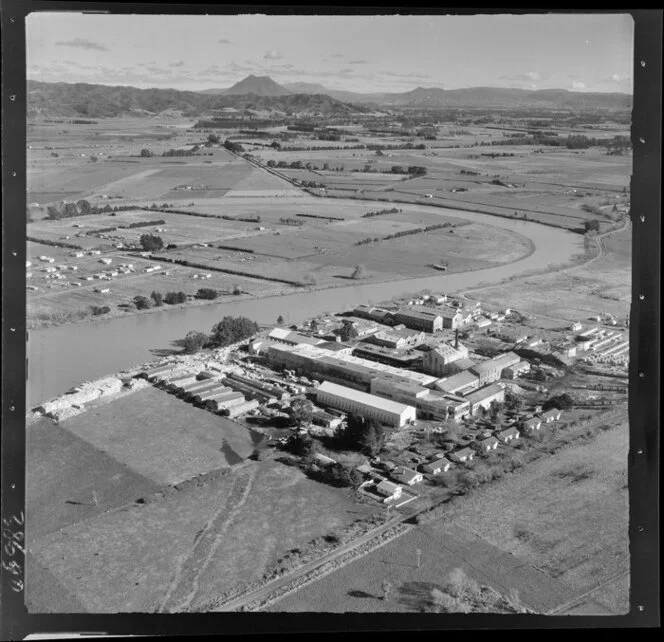 Whakatane Board Mills, Whakatane, Bay of Plenty, showing wood pulp processing plant besdides the Whakatane River, with view inland to farmland and Mt Edgecumbe beyond