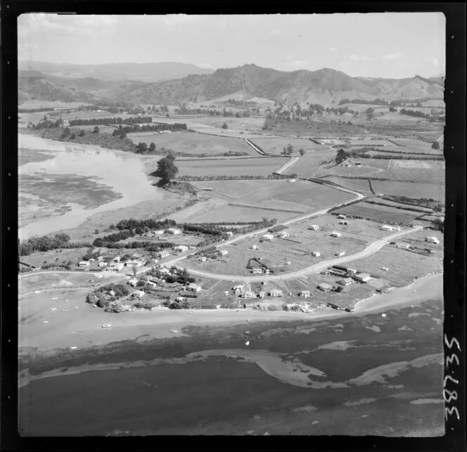 Bowentown, Tauranga, Bay of Plenty, showing a view of a peninsula, northern section of Tauranga inner harbour, with housing along Athenree Road and Roretana Drive and tidal flats with farmland beyond