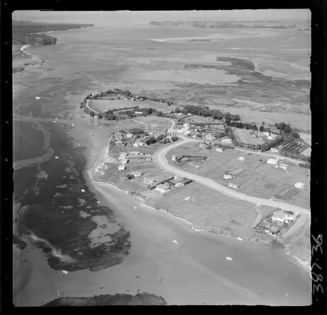 Bowentown, Tauranga, Bay of Plenty, showing view of a peninsula with tidal flats, northern section of Tauranga inner harbour, with housing along Athenree Road and Roretana Drive, looking out to Bowentown Heads and harbour entrance beyond