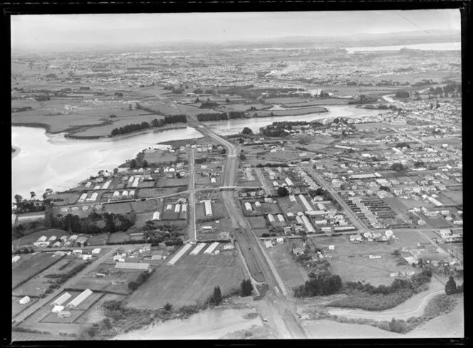 Showing Tamaki River with bridge and Southern Motorway under construction through residential area, looking south with Princess Street East and Frank Grey Place, Otahuhu, Auckland