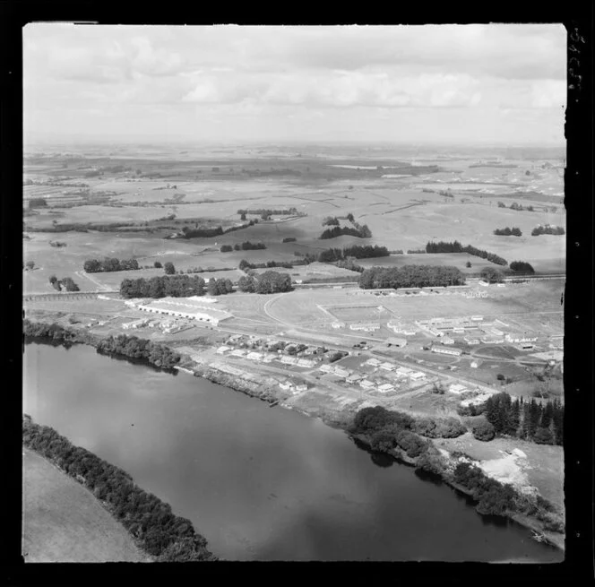 Ngaruawahia, Waikato, view of Hopuhopu Military Camp on the banks of the Waikato River with training grounds, barracks, residential housing and rugby field, farmland beyond