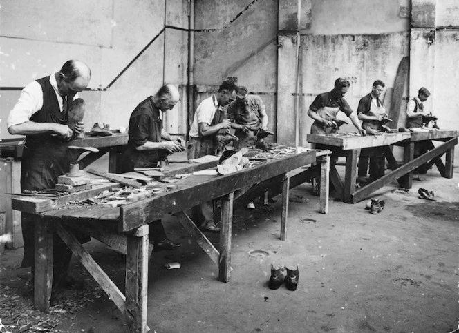 Relief workers repairing second hand boots