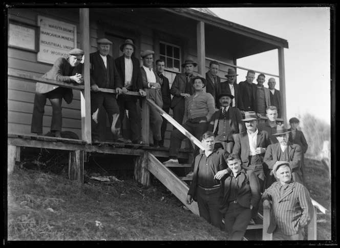 Group of miners outside Waiuta Branch Inangahua Miners Industrial Union of Workers library building