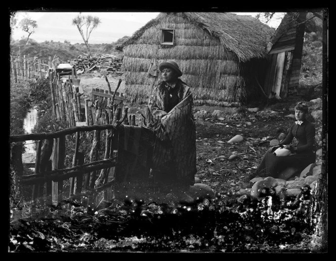 Women and raupo whare, Karaka Bay, Wellington