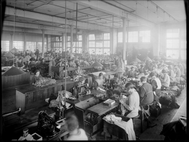 Clothing factory interior, showing female staff sewing garments on sewing machines, location unidentified