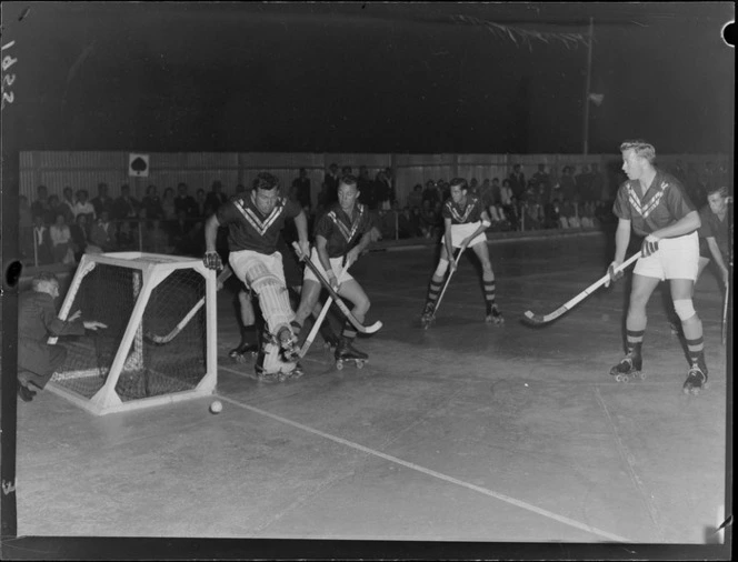 Unidentified team of men playing roller hockey on a rink in Lower Hutt