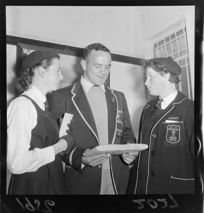 A J van der Merwe, Springbok rugby union football player on the 1956 tour, talking to two unidentified Wellington East Girls College pupils