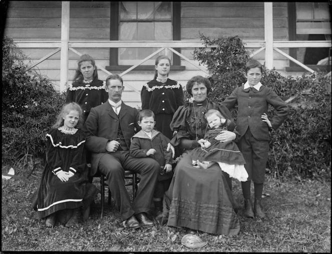 Family group in front of house