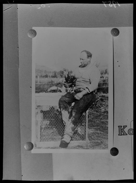 West Coast farmer and mass-murderer Stanley Graham, sitting on a chicken coop