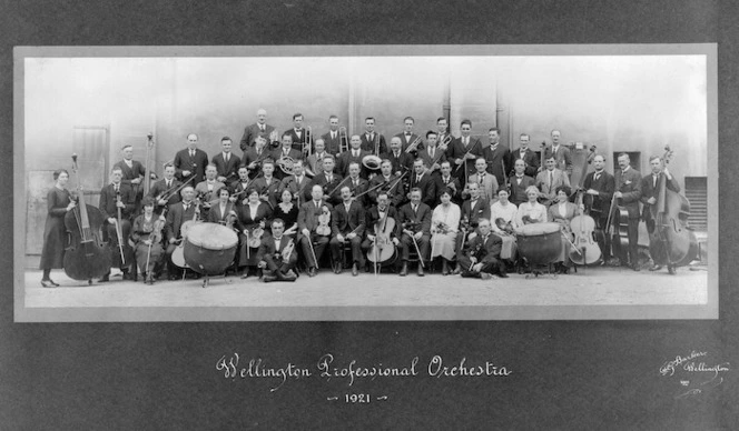 Members of the Wellington Professional Orchestra with their instruments and, sitting in the front row, their conductor (Moschini?)