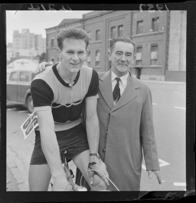 An unidentified cyclist [the winner?], who has taken part in a race from from Palmerston North to Wellington, with another unidentified man alongside