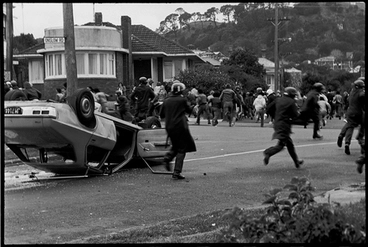 Image: The anti-Tour protest group retreats from the Red Squad baton charge as it passes the overturned unmarked police car and arrives at Dominion Rd