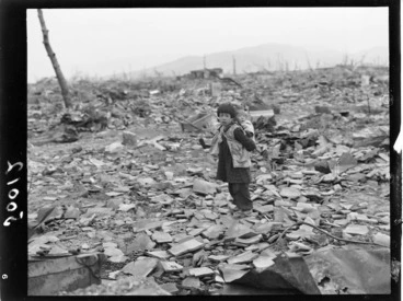 Image: Hiroshima - Small child with baby on back searching for anything of usefulness