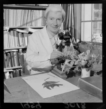 Image: Lucy Beatrice Moore, botanist, looking at a plant specimen with a microscope