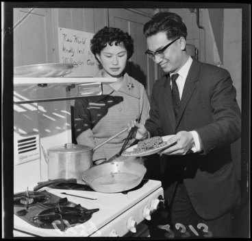 Image: Mr Li and Miss F Wong Shee, demonstrating Chinese cookery on a gas stove, probably Wellington