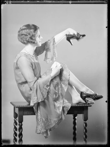 Image: Female model holding a shoe