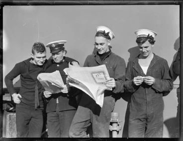 Image: Sailors from HMS Leander, reading newspapers