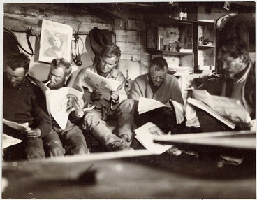 Image: Men reading newspapers during the British Antarctic Expedition (1907-1909)