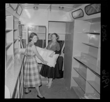 Image: Two unidentified women [librarians?] showing the interior of the new Country Library Service mobile library