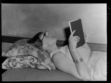 Image: An unidentified young woman models a new style of reading glasses