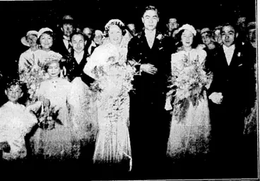 Image: Evening Tost" Thoto. The picturesque wedding of Lucy, daughter of Mr. and Mrs. K. C. Fore, of Wanganui, and Arthur, fifth son of Mr. and Mrs. Chin Ting, of Wellington, took place at St. Mark's Church last night. The photograph shotvs the bridal party leaving the church. (Evening Post, 06 February 1936)