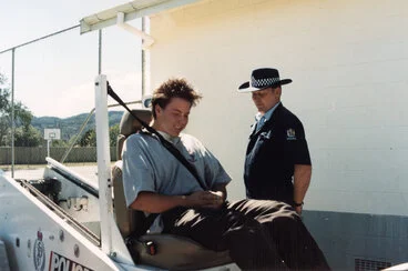 Image: Heretaunga College; road safety; Lyndon Kokay on seat-belt sled; senior constable Chris Best.