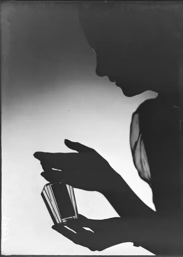 Image: Showing a dark outline of a woman holding a cosmetic bottle, for Sargood Son and Ewen 1940