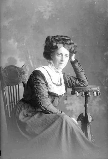 Image: 3/4 portrait of Miss Millar seated, her left elbow on books,....