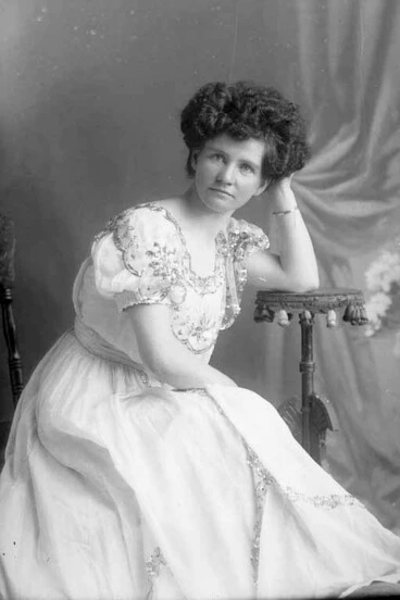 Image: 3/4 portrait of Miss Nicholson seated leaning her left elbow on....