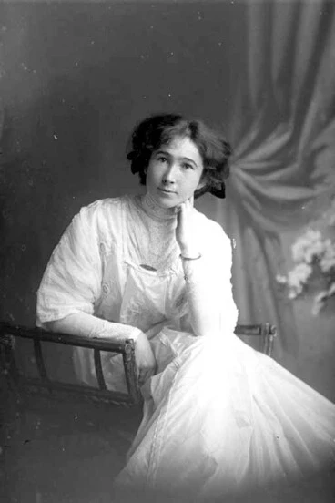 Image: 3/4 portrait of Miss Robinson seated, leaning her left elbow on....