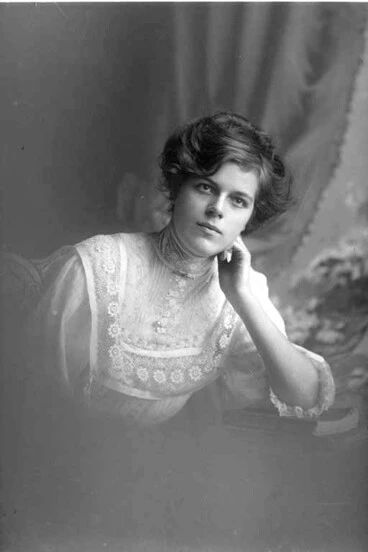 Image: 1/2 portrait of Miss Staples seated, leaning left elbow on....