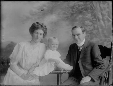 Image: 3/4 length portrait of the Mitchell family group, the man on....