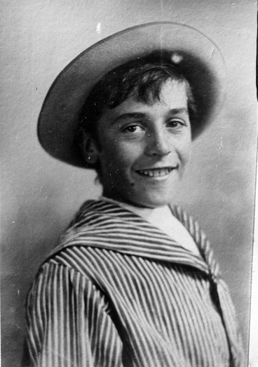 Image: A boy in a hat and a striped sailors style shirt