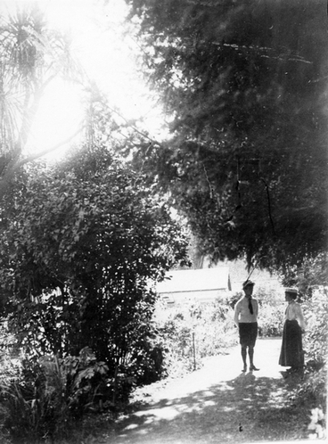 Image: A man and a woman standing in a garden