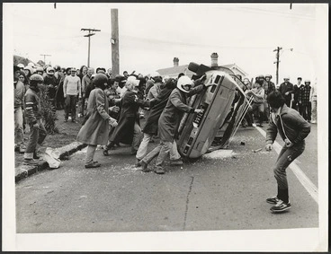 Image: Anti Springbok tour demonstrators overturn a car, Auckland, New Zealand - Photograph taken by an Auckland Star photographer