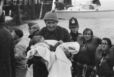 Image: Policeman Ray Ruane holding a young survivor of the Wahine shipwreck