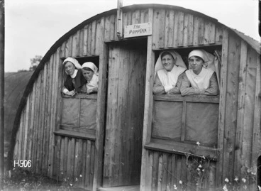 Image: Four nursing sisters look out of the windows of the New Zealand Stationary Hospital, Wisques, France