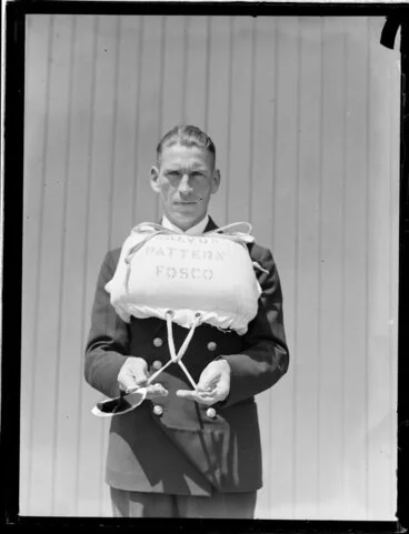 Image: Tasman Empire Airways Ltd crew member demonstrating use of life jacket