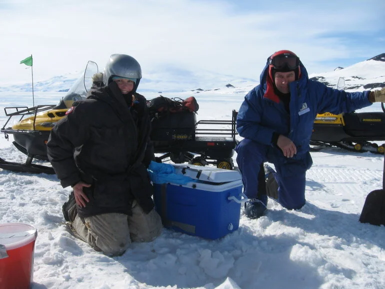 Image: Returning surplus fish, Victoria Metcalf and Chef Basil, McMurdo Sound