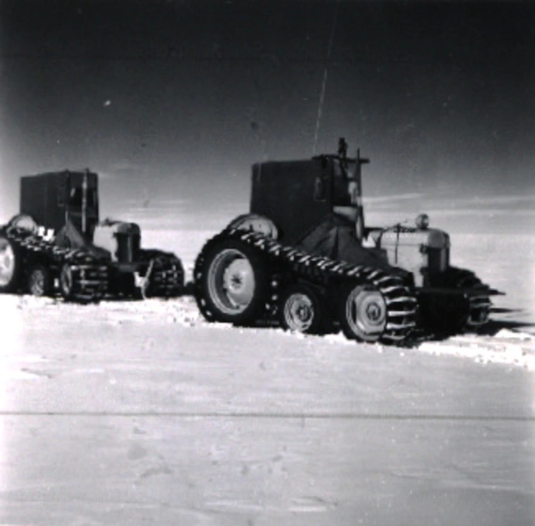 Image: Ferguson tractor Sue with sun compass, leads across the undulating Polar Plateau, roped to the tractors behind