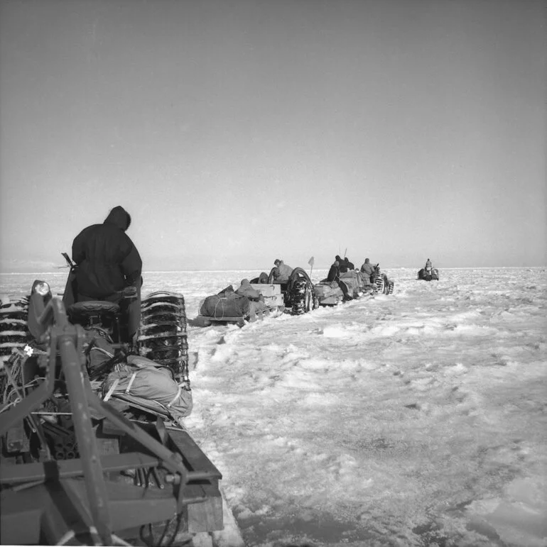 Image: A tractor train sets out on a reconnaissance trip seeking a trail to the Butter Point site