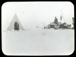 Image: [Man with sled full of supplies next to a tent]
