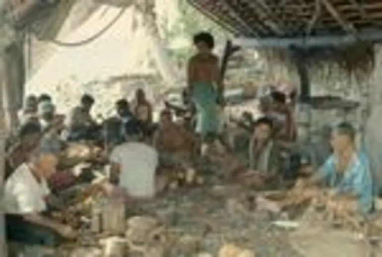 Image: Elders and men making craft objects.