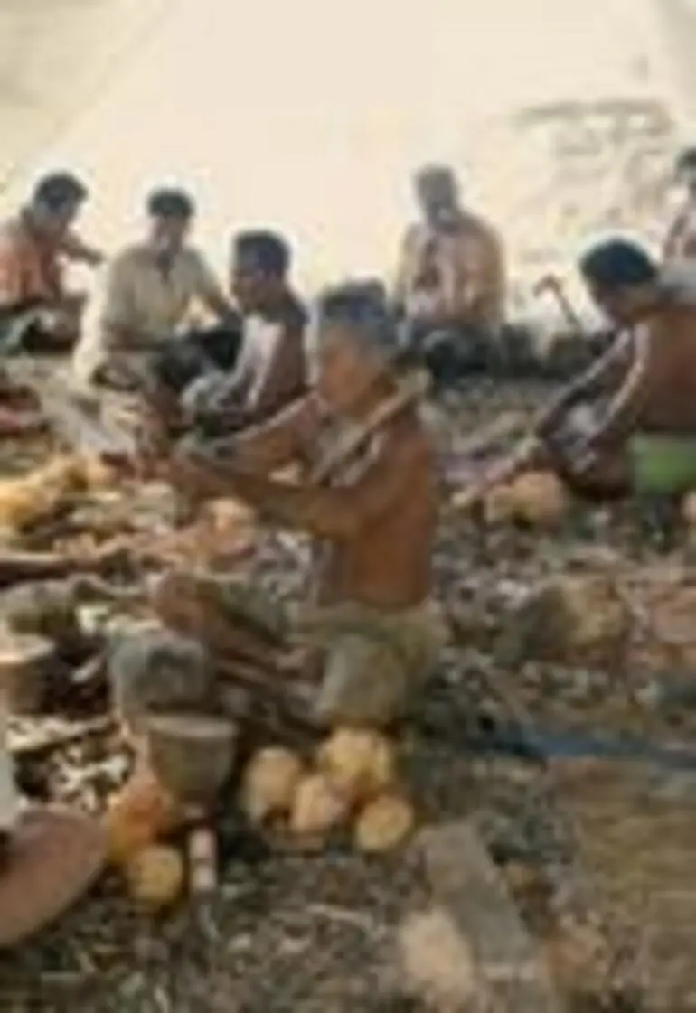 Image: Elders and men making craft objects.