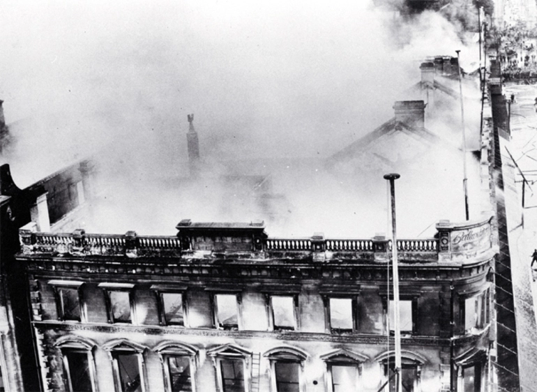 Image: View of still smoking Ballantyne's building from the corner of Cashel and Colombo Streets, Christchurch